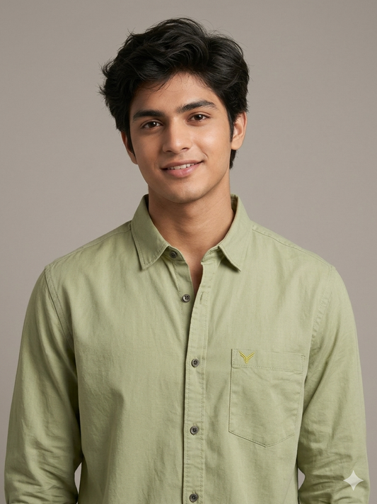 Man wearing a COTTON light green shirt against a neutral background